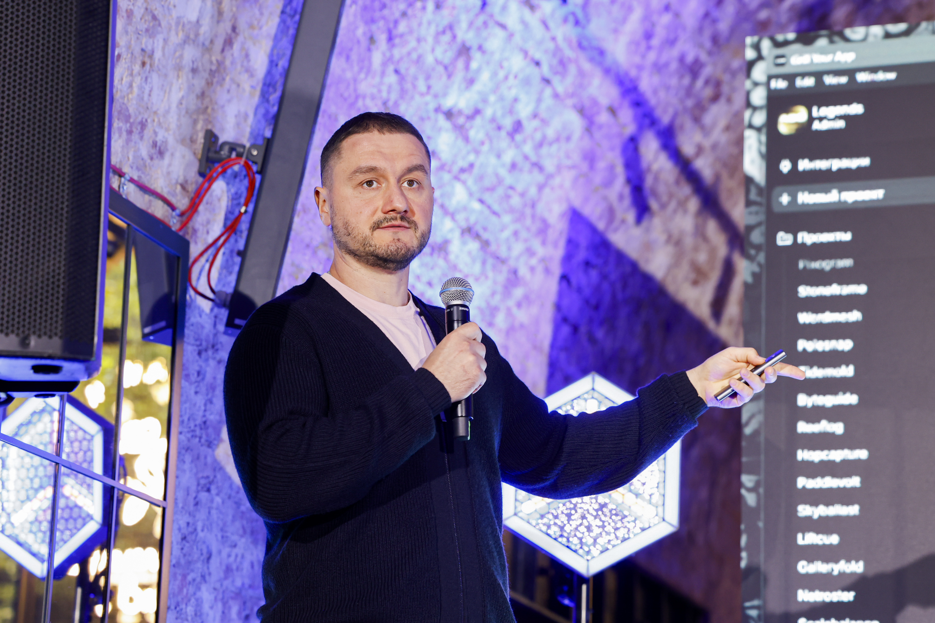 Oleksa Braila, CEO of Epic Team, speaking at AGS Warsaw meetup with a presentation on screen about the top 5 things AI still can't do for your business.